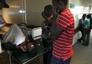 Amigos de una víctima lesionada en el Hospital Nacional Kenyatta, después de una explosión dentro de la Iglesia Internacional de los Milagros en Nairobi. 
