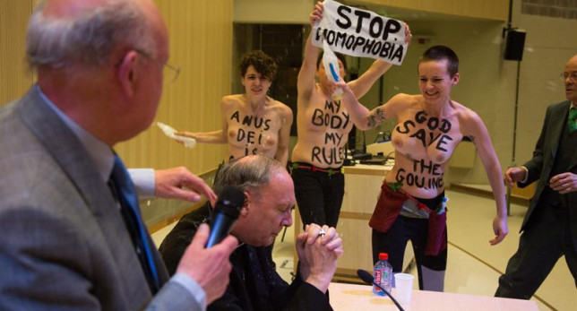 Feministas de Femen arrojan agua bendita al presidente de la Conferencia Episcopal belga, un acto que, según las leyes españolas, sería considerado de "agresión" y no un delito de odio.