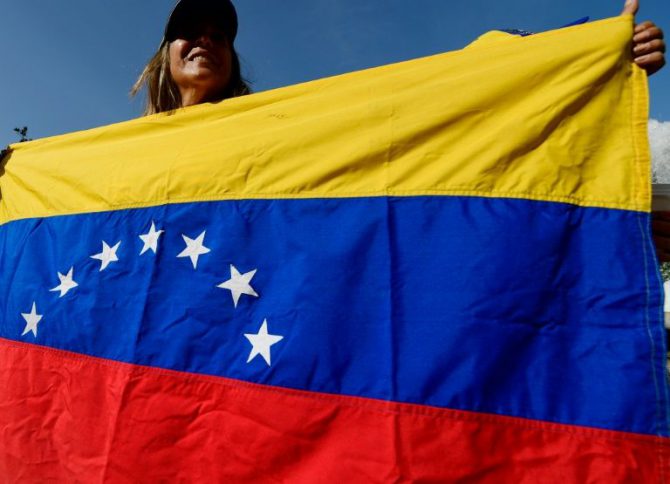 Una mujer enarbola una bandera de Venezuela en una manifestación en Madrid, para pedir la revocación del mandato de Nicolás Maduro, el 4 de septiembre de 2016