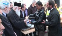 El arzobispo Jerónimo de Atenas y toda Grecia distribuye comida a migrantes en el puerto del Pireo. El arzobispo se quitó el crucifijo durante su visita al Pireo, para, dijo, no “ofender” a los migrantes musulmanes. (Imagen: pantallazo de un vídeo de Hellas News TV)
