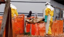 Dos sanitarios portan a un enfermo de ébola, en un centro de la República Democrática del Congo